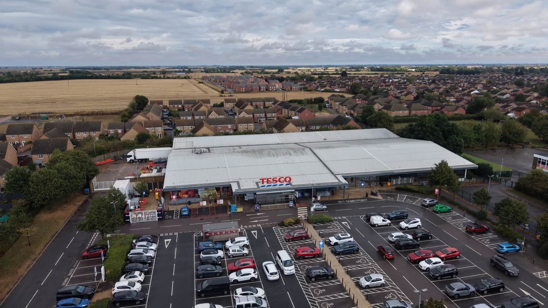 Supermarket, service yard and car park seen from above
