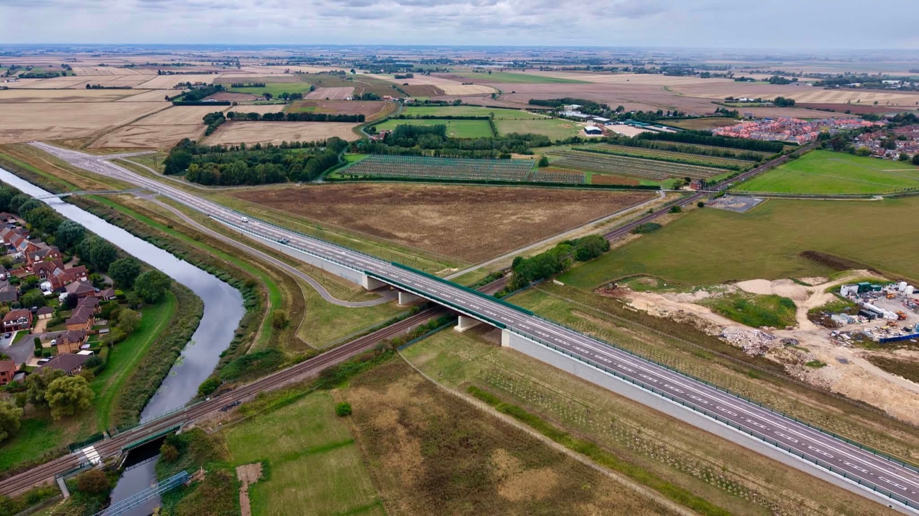 Completed road bridge crossing a railway line and river